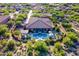 Expansive backyard with a pool, luxury seating, outdoor kitchen, and lush landscaping create a private retreat at 35443 N 87Th Pl, Scottsdale, AZ 85266