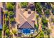 An aerial shot of a home with a tile roof surrounded by desert landscape and privacy walls at 35443 N 87Th Pl, Scottsdale, AZ 85266
