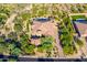 Aerial view shows a desert home with a circular driveway and lush desert landscaping at 35443 N 87Th Pl, Scottsdale, AZ 85266