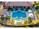 The aerial view showcases a sparkling pool, outdoor kitchen, and luxurious seating surrounded by mature landscaping at 35443 N 87Th Pl, Scottsdale, AZ 85266