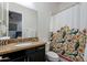 A bathroom with dark cabinets, granite counters and a mirror at 35443 N 87Th Pl, Scottsdale, AZ 85266