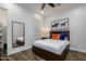 This is a modern bedroom with dark wood floors, a dark bedframe, and a full-length mirror at 35443 N 87Th Pl, Scottsdale, AZ 85266