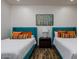 A bright bedroom showcasing two beds with colorful accents and a decorative birch tree art print at 35443 N 87Th Pl, Scottsdale, AZ 85266