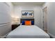 This bedroom features a queen-sized bed with dark wood floors, an art piece and a window at 35443 N 87Th Pl, Scottsdale, AZ 85266