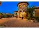 Home with a circular stone turret and arched doorway at 35443 N 87Th Pl, Scottsdale, AZ 85266