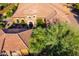 Aerial view of the front entrance showcasing a stone turret and desert landscaping at 35443 N 87Th Pl, Scottsdale, AZ 85266