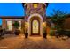 Home with a circular stone turret and arched doorway at 35443 N 87Th Pl, Scottsdale, AZ 85266