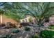Landscaped front yard with desert plants and trees, providing shade and natural beauty to the home at 35443 N 87Th Pl, Scottsdale, AZ 85266