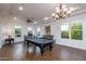 Well-lit game room featuring a billiard table, ample seating, and a stylish chandelier at 35443 N 87Th Pl, Scottsdale, AZ 85266