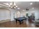 Expansive game room with a billiard table, custom lighting, and seamless transition to other living areas at 35443 N 87Th Pl, Scottsdale, AZ 85266