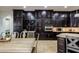 Gourmet kitchen featuring wine fridge and dark cabinets at 35443 N 87Th Pl, Scottsdale, AZ 85266