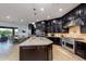 Gourmet kitchen features dark cabinets and large island with seating at 35443 N 87Th Pl, Scottsdale, AZ 85266