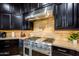 Stainless steel range hood in a gourmet kitchen with dark cabinets at 35443 N 87Th Pl, Scottsdale, AZ 85266