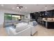 Bright living room features a large sectional sofa, club chairs and an oversized glass slider at 35443 N 87Th Pl, Scottsdale, AZ 85266