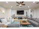 Living room with built-in shelving, a modern fireplace, and comfortable seating at 35443 N 87Th Pl, Scottsdale, AZ 85266