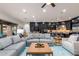 Open-concept living room boasts comfortable seating, a decorative rug, and dark wood accents at 35443 N 87Th Pl, Scottsdale, AZ 85266