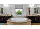 The main bathroom features dual vanities, a drop-in tub, and a large window offering backyard views at 35443 N 87Th Pl, Scottsdale, AZ 85266