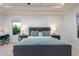 Bright main bedroom with tray ceilings, carpeted floors, two windows, and a desk area to the left at 35443 N 87Th Pl, Scottsdale, AZ 85266