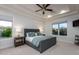 Spacious main bedroom boasting tray ceilings, two windows, a ceiling fan, and neutral-colored walls at 35443 N 87Th Pl, Scottsdale, AZ 85266