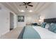 Light-filled main bedroom features tray ceilings, carpeted floors, a workstation, and ensuite bathroom access at 35443 N 87Th Pl, Scottsdale, AZ 85266