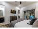 This primary bedroom offers a door to the patio, a ceiling fan and a flat screen television for the ultimate relaxation at 35443 N 87Th Pl, Scottsdale, AZ 85266