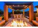 Outdoor dining under a pergola with a built-in grill and bar, complemented by a cozy fire pit at 35443 N 87Th Pl, Scottsdale, AZ 85266
