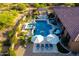 Aerial view of a backyard featuring a pool, spa, outdoor kitchen, and lounge areas at 35443 N 87Th Pl, Scottsdale, AZ 85266