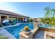 Sparkling pool and spa with lush landscaping and a covered seating area at 35443 N 87Th Pl, Scottsdale, AZ 85266