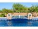 Beautiful fountain feature in the sparkling pool with lush desert landscaping at 35443 N 87Th Pl, Scottsdale, AZ 85266