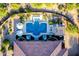 Aerial view of a luxury pool with lounge areas, an outdoor kitchen, and desert landscaping at 35443 N 87Th Pl, Scottsdale, AZ 85266
