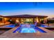 An alluring backyard oasis includes a pool, fire bowls, and a smooth transition to the open living space at 35443 N 87Th Pl, Scottsdale, AZ 85266