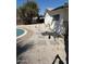 Landscaped backyard featuring pool, stepping stones, gravel, and black wrought iron fence at 3933 E Flower St, Phoenix, AZ 85018