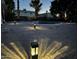 Serene backyard illuminated by landscape lighting and a tranquil pool at 3933 E Flower St, Phoenix, AZ 85018