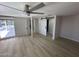 Finished basement with modern floors, a ceiling fan, and convenient sliding barn doors at 3933 E Flower St, Phoenix, AZ 85018