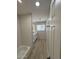 Bright bathroom featuring a modern vanity, a tub with tile surround, and wood-look floors at 3933 E Flower St, Phoenix, AZ 85018