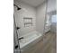 Stylish bathroom with a tub shower combo, modern vanity, and bright, natural light at 3933 E Flower St, Phoenix, AZ 85018