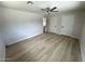 Bedroom featuring wood-look flooring, neutral paint, a ceiling fan, and two closets for ample storage at 3933 E Flower St, Phoenix, AZ 85018