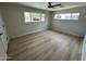 Bright bedroom featuring wood-look floors and large windows offering plenty of natural light at 3933 E Flower St, Phoenix, AZ 85018