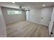 Neutral bedroom with light wood flooring, ceiling fan, and window with natural light at 3933 E Flower St, Phoenix, AZ 85018