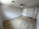 Large bedroom with wood-look floors, a ceiling fan, and two closets for ample storage at 3933 E Flower St, Phoenix, AZ 85018