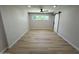 Spacious bedroom with light wood floors, fan and window providing natural light at 3933 E Flower St, Phoenix, AZ 85018