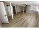Bedroom with modern flooring, barn door, and a ceiling fan for comfort at 3933 E Flower St, Phoenix, AZ 85018