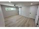 Neutral bedroom featuring light wood floors, natural lighting, and a sliding closet door at 3933 E Flower St, Phoenix, AZ 85018