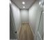 Narrow walk-in closet with light wood-style flooring and neutral paint at 3933 E Flower St, Phoenix, AZ 85018