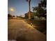 A well lit driveway and front yard landscaping are the main feature of this house at 3933 E Flower St, Phoenix, AZ 85018
