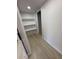 Hallway with white walls, new flooring, and shelving at 3933 E Flower St, Phoenix, AZ 85018