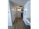 Hallway with built-in storage and light-colored wood-look flooring at 3933 E Flower St, Phoenix, AZ 85018