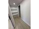 Hallway with shelving and wood-look flooring leading to an open doorway at 3933 E Flower St, Phoenix, AZ 85018