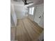 The hallway has updated flooring and well-lit with neutral walls and bright door at 3933 E Flower St, Phoenix, AZ 85018