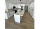 Bright and airy kitchen with white cabinetry, island, stainless appliances, and modern pendant lighting at 3933 E Flower St, Phoenix, AZ 85018